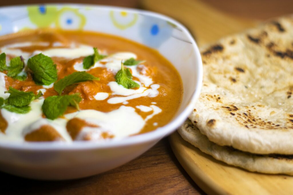 Creamy chicken curry with fresh mint and naan bread (illustrative photo)