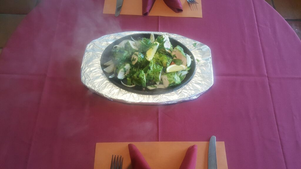 A steaming sizzler plate served at the table