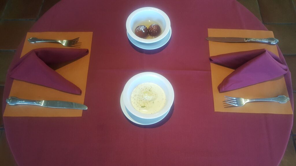 Two bowls served on a table set for two